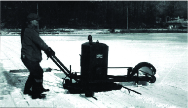 A black-and-white photo of a man harvesting ice using a gas-powered saw, from a lake in Franklin, NJ. Photo Source: "Images of America Sussex County" by Wayne T. McCabe