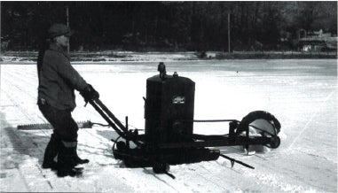 A black-and-white photo of a man harvesting ice using a gas-powered saw, from a lake in Franklin, NJ. Photo Source: "Images of America Sussex County" by Wayne T. McCabe