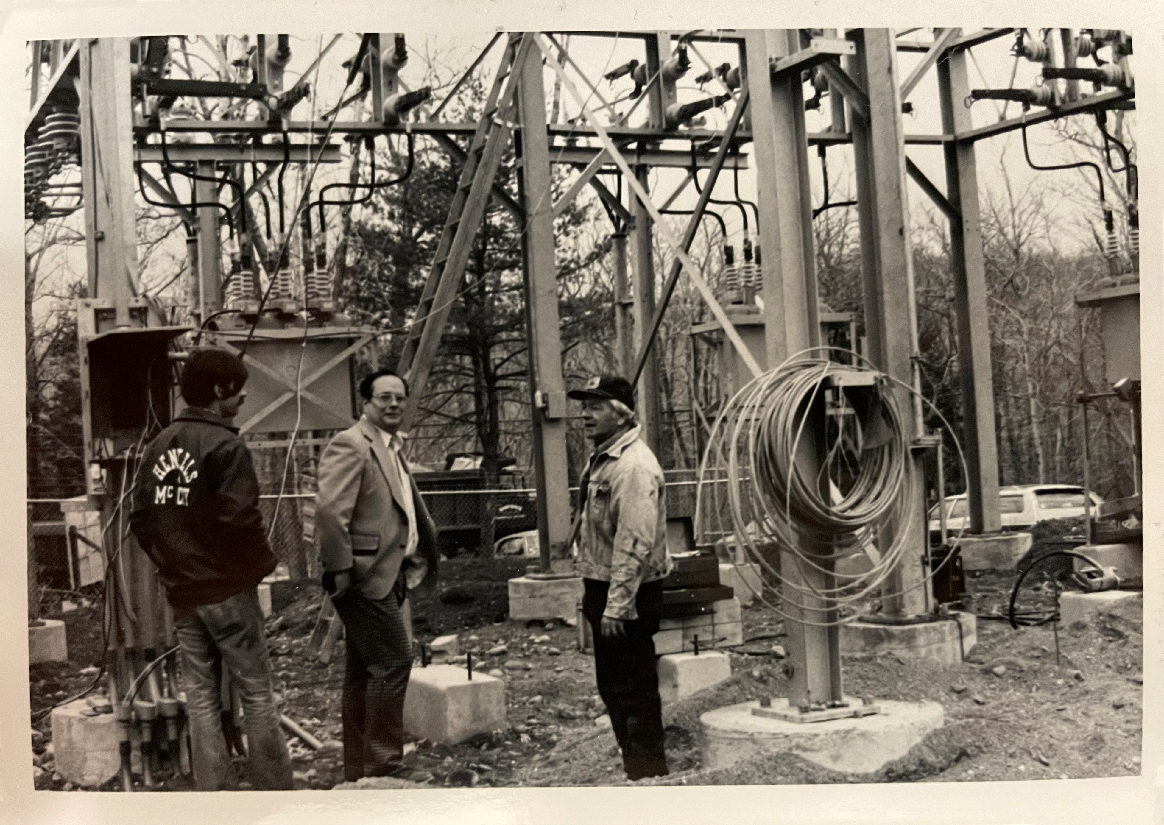 Pictured: 1978 black-and-white photo of SREC workers in the newly constructed Barry Lakes substation, which serves the Barry Lakes area, Lake Wanda, and portions of Highland Lakes.