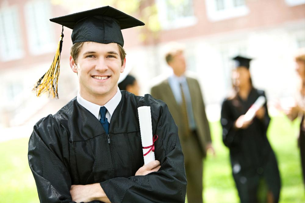 Male graduate poses with his diploma