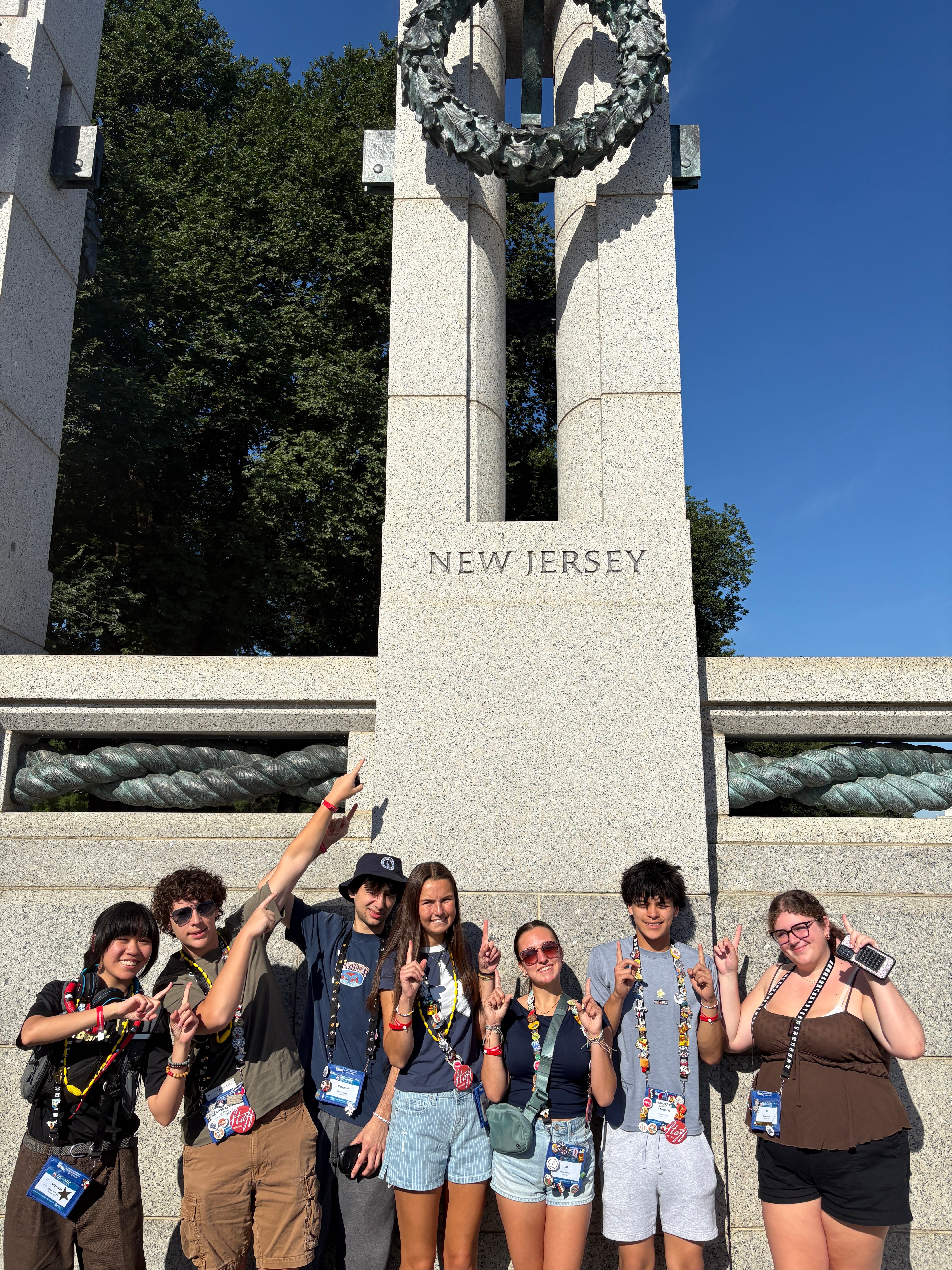NJ Youth Tour students point upward at the New Jersey monument at Washington, D.C.'s World War II Memorial
